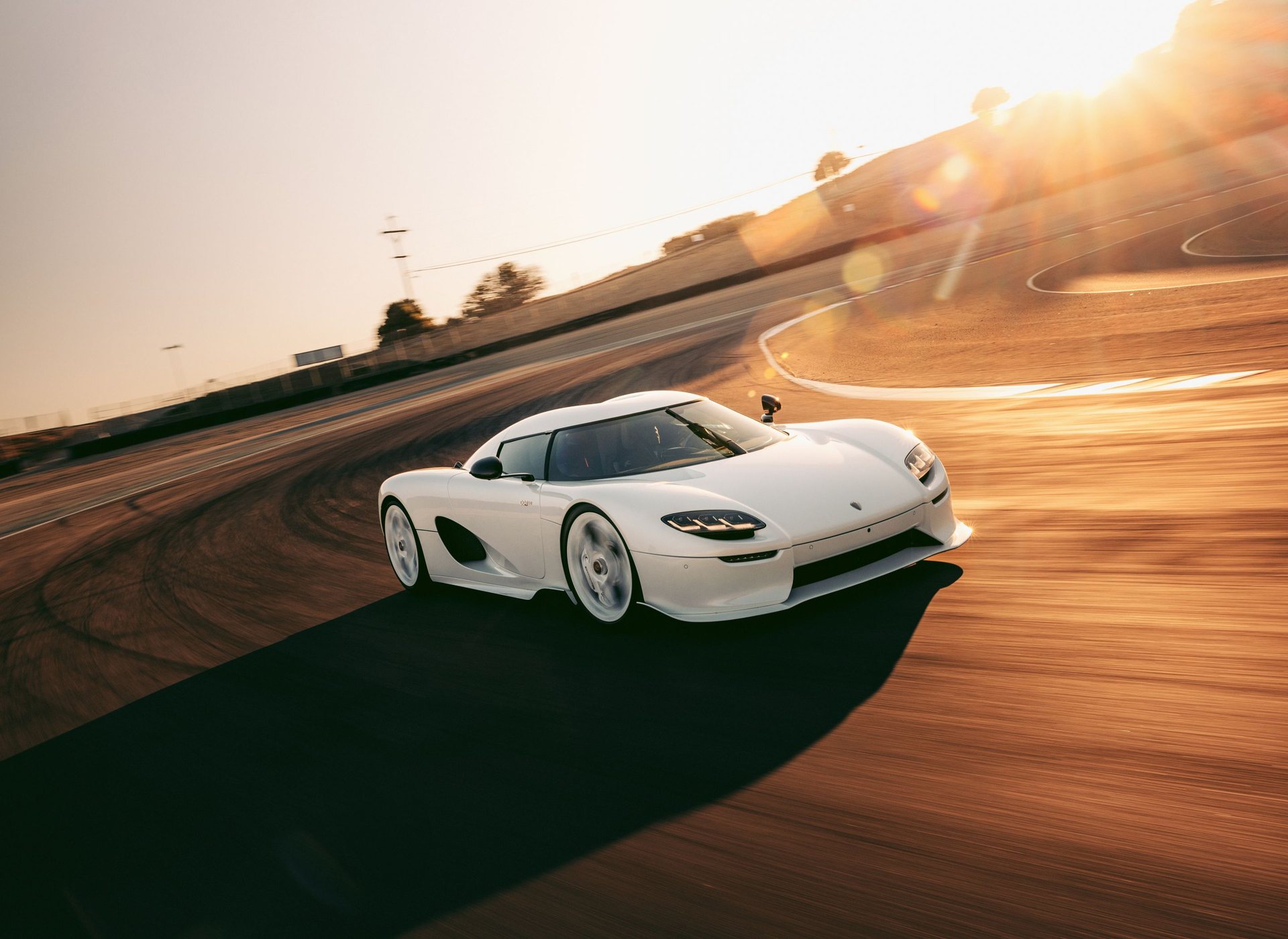 A white Koenigsegg CC850 at speed