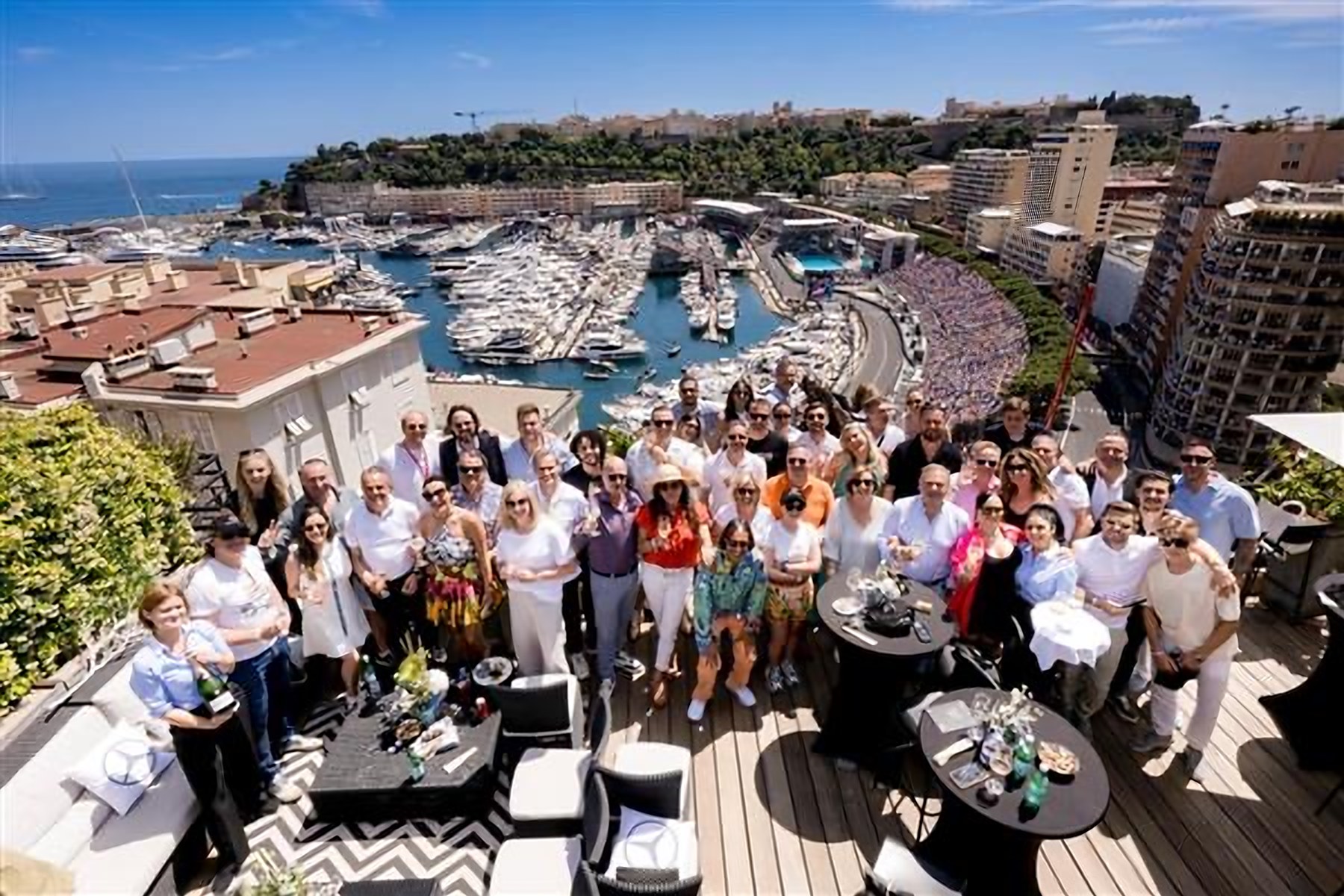 Guests on the terrace on a Mercedes race day, the harbour and circuit below